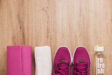 Sport flat lay with sneakers yoga mat on wooden floor background,Sport top view concept.
