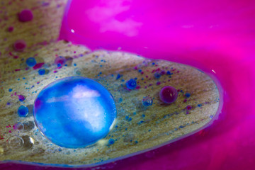 Obraz premium colored oil drops in water on a gray