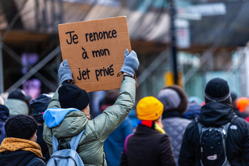 Activists marching for the environment. French sign seen in an ecological protest saying i renounce...