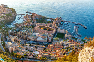 Aerial view of stadium of Monaco at sunrise, view from La Turbie, landmark of Monaco, Monte-Carlo, port Cap Dail, port Fontvieille, Monaco Ville,  blue sea, morning - obrazy, fototapety, plakaty