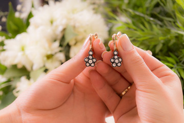 hands with earring and flower