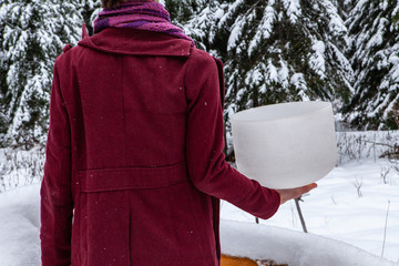 Man is holding a native sacred drum. Man wearing red urban clothing is holding his crystal bowl in...