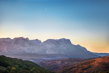 Mountains view with hairpin turn road with aircraft trail in sky and mountains background, Durmitor...