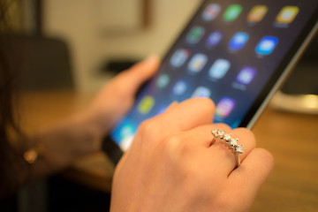 hand of woman use tablet pc with diamond ring