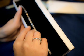 hand with diamond ring and jewelry box