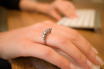 woman use computer with diamond ring