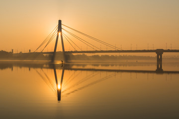 Silhouette of Northern bridge during golden hour at sunrise in Kyiv, Ukraine