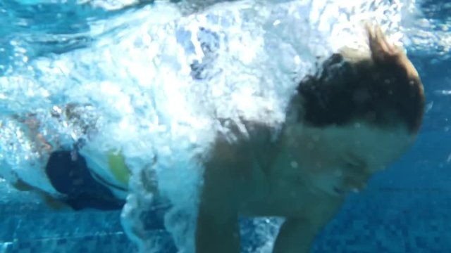 Child diving underwater in super slow-motion 240fps