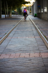person riding a bike down a train track