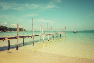 Wooden platform entering the turquoise sea on Koh Sameth island in Thailand.