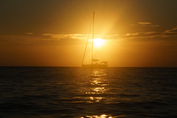 Fototapeta premium sailboat sailing on the horizon during sunset