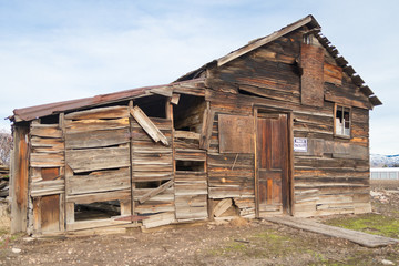 Wooden shack/barn in abandoned disrepair, featuring faded "PRIVATE PROPERTY" sign.