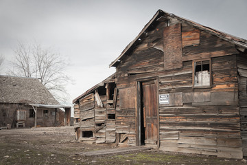 Wooden shack/barn in abandoned disrepair, featuring faded "PRIVATE PROPERTY" sign.