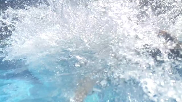 Kids jumping inside swimming pool water in ultra slow-motion 240fps
