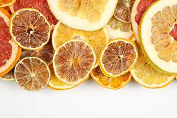 Dried slices of various citrus fruits closeup on white background