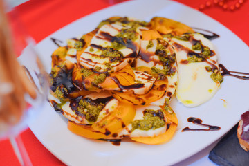 fried cheese and yellow pepper on a white plate selective focus
