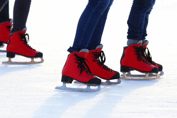 Female legs in skates on an ice rink