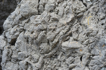 Gray stone background with rough texture and cracks.
