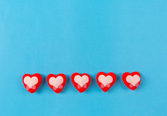 Valentines day background with red heart and gift box on blue background.