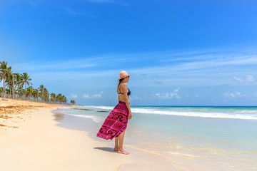 Nice look woman staring the sea in a empty amazing beach