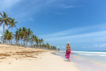 Beautiful woman walking in a empty beach in Caribe
