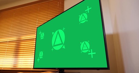 A slow dolly shot of a typical home flatscreen television. Green screen with optional tracking points for screen replacement. Pre-tracked AE comp available upon request.  	