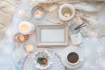 Details of still life in the home interior. Aroma stick, interior items, candles, frame for text, Moody. Cosy autumn winter light concept. Copy space, monochrome, toned photo