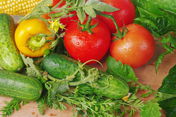 Tomatoes and cucumbers on the kitchen board. Close-up