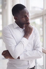 serious african business man thinking or planning; portrait of thoughtful black man thinking, planning, considering, finding a good idea; young adult african man model