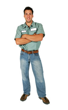 An adult male serviceman employee worker with blank name tag on shirt standing with his arms folded.