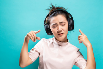 Fototapeta premium Happy woman dancing and listening to the music