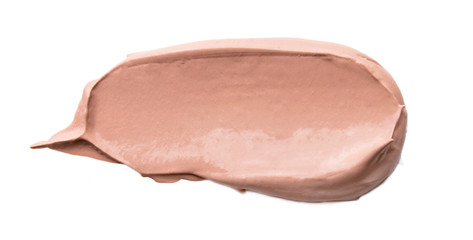 Close-up of liquid cosmetic foundation smudge isolated on white background