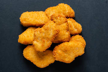 chicken nuggets on the black background
