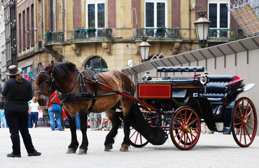 Naklejka na ściany i meble Traditional horse-drawn carriage in Amsterdam, the Netherlands
