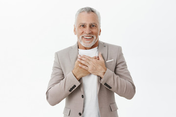 Old man receiving heartwarming and touching gift pleased and delighted smiling with crooked teeth...