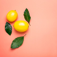 ripe lemons on Living coral background. Healthy food concept