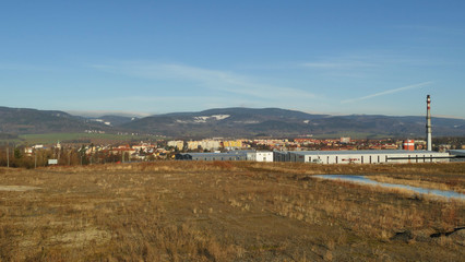 Aerial view of town Ostrov nad Ohri in front of Ore Mountains with highest peak Klinovec