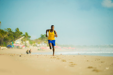 young attractive fit athletic and strong black African American man running at the beach training...