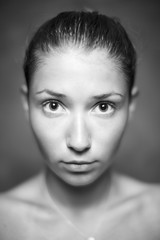 Fototapeta premium Young girl with beautiful skin and no makeup in black and white.