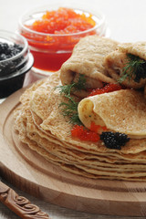 Russian pancakes with red and black caviar