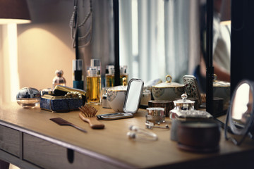 many stuffs on a dressing table in a bedroom