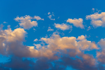 Naklejka na ściany i meble Clouds in the sky at sunset as a background