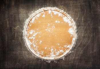 wheat flour and cutting board on wooden background