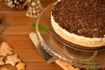 chocolate mousse cake with brownie base on rustic table / background 