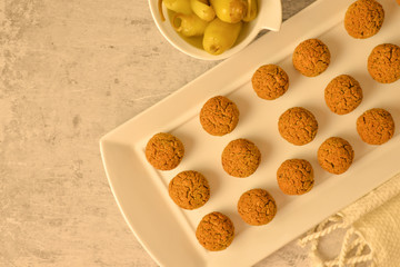 Baked chickpea falafel balls on white plate on grey background , healthy and vegan food with tahini deep and hot pepper , traditional Mediterranean , top view , flat lay 