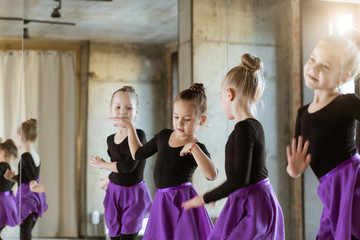 Cute little kids dancers on dance studio. Choreographed dance by a group of small ballerinas...