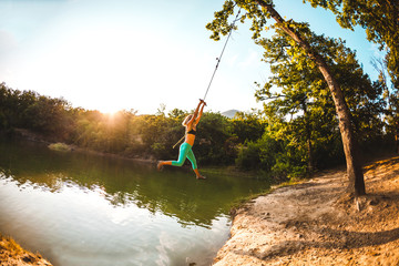 A woman is riding a swing.