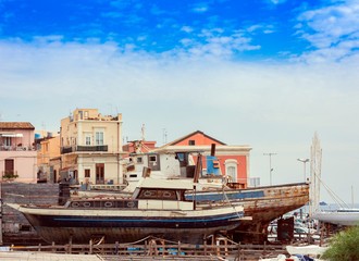 Acitrezza harbor with fisher boats next to Cyclops islands, Catania, Sicily, Italy.