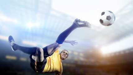 Soccer player in action on stadium background. © efks