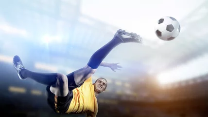 Fotobehang Soccer player in action on stadium background. © efks